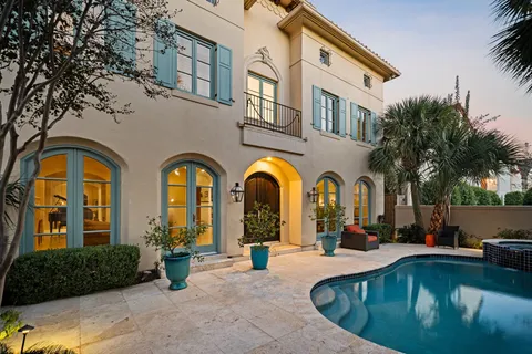 a view of a swimming pool with palm trees