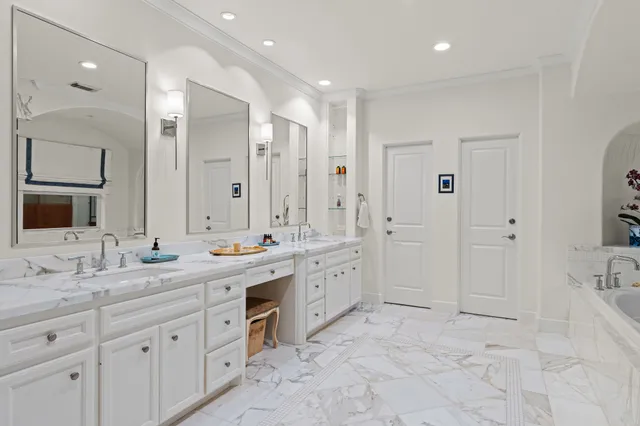 a spacious bathroom with a bathtub shower sink and mirror