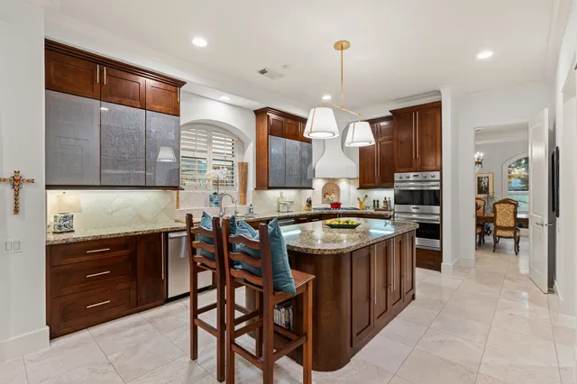 a kitchen with a sink counter top space appliances and cabinets
