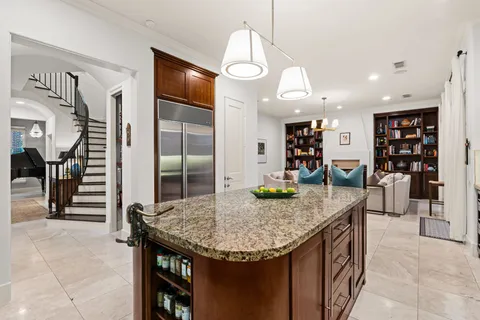 a kitchen with stainless steel appliances granite countertop a refrigerator and a sink