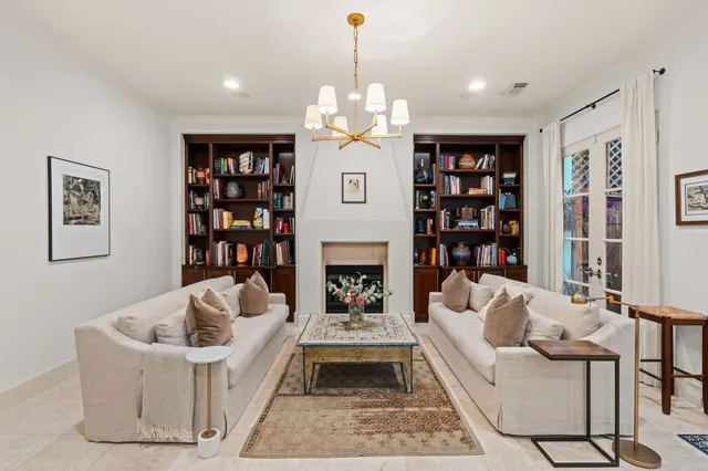 a living room with furniture fireplace and book shelf
