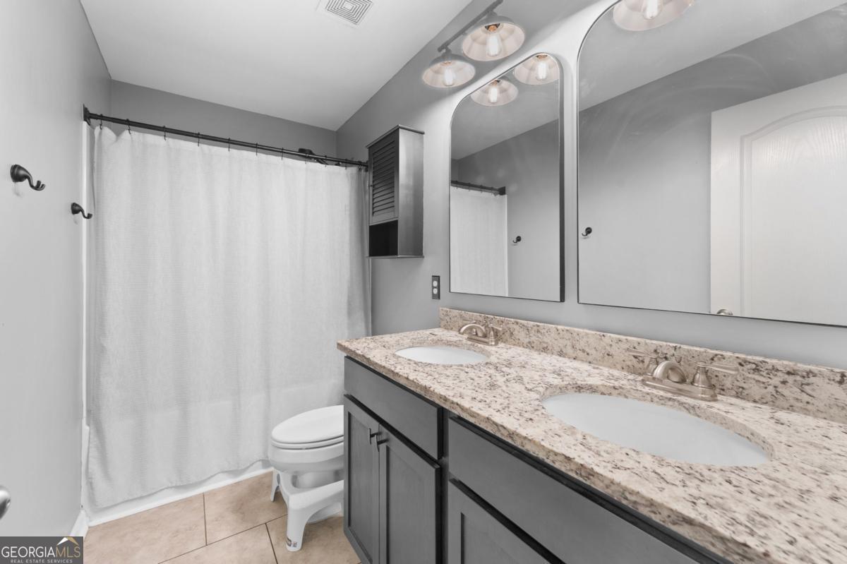 91 Crestview Drive Guyton, GA 31312 - Photo 59 of 85 a bathroom with a granite countertop sink and a mirror