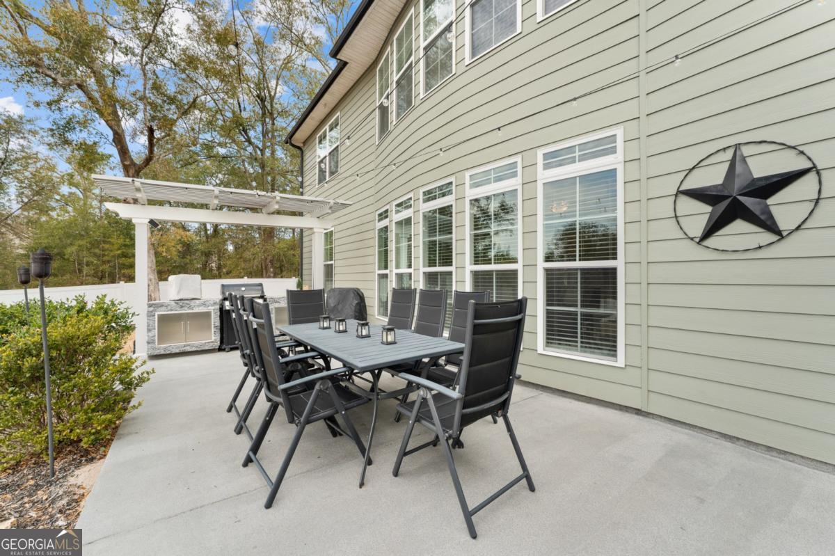 91 Crestview Drive Guyton, GA 31312 - Photo 64 of 85 a view of a patio with a table and chairs and potted plants
