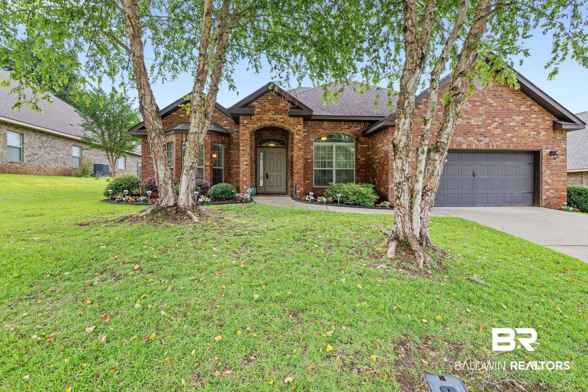 2554 Masters Court Mobile, AL 36618 - Photo 1 of 35 Traditional home featuring brick siding, an attached garage, concrete driveway, a front yard, and a shingled roof