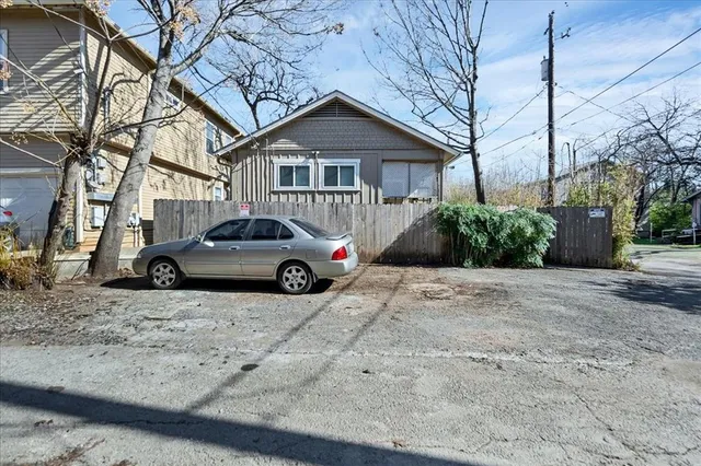 a view of a car parked in front of a house