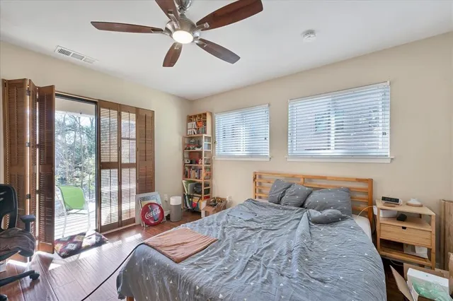 a bedroom with a bed and a large window