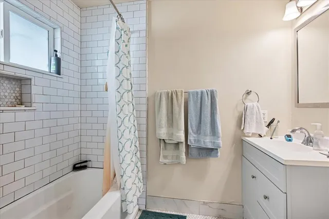 a bathroom with a sink a bathtub and a shower