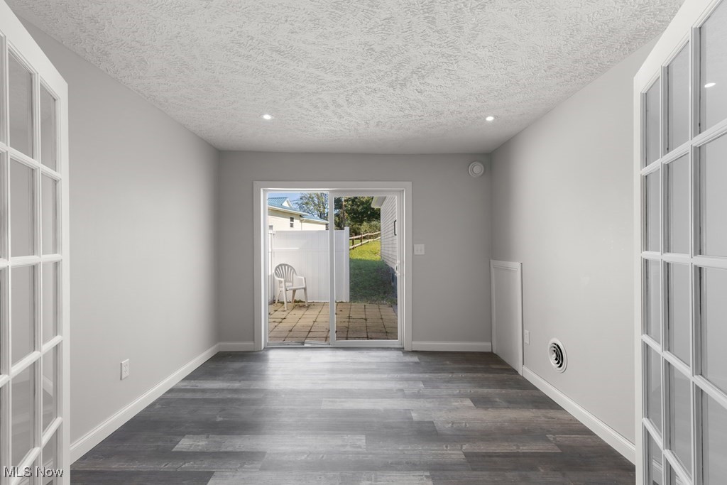 139 Patterson Road Weirton, WV 26062 - Photo 9 of 46 Unfurnished room featuring recessed lighting, dark wood finished floors, a textured ceiling, and french doors