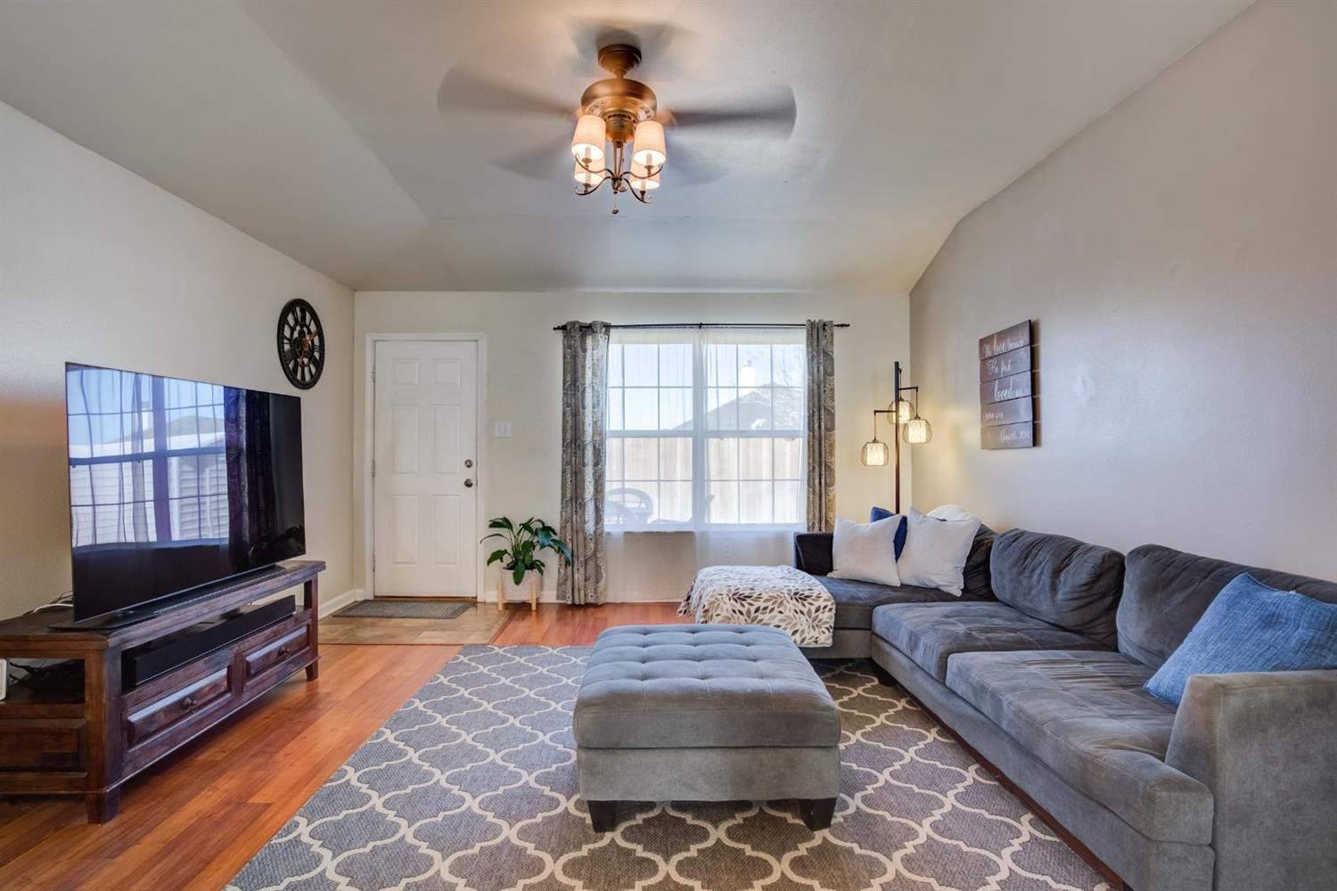 6514 86th Street Lubbock, TX 79424 - Photo 11 of 34 a living room with furniture a flat screen tv and a window