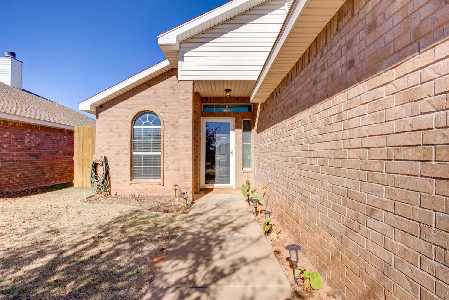 6514 86th Street Lubbock, TX 79424 - Photo 2 of 34 a front view of a house with a yard