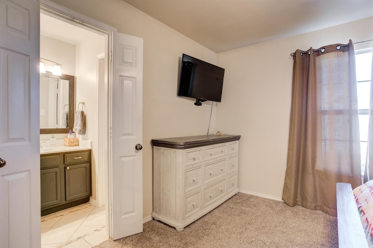 6514 86th Street Lubbock, TX 79424 - Photo 21 of 34 a bathroom with a sink a mirror and shower