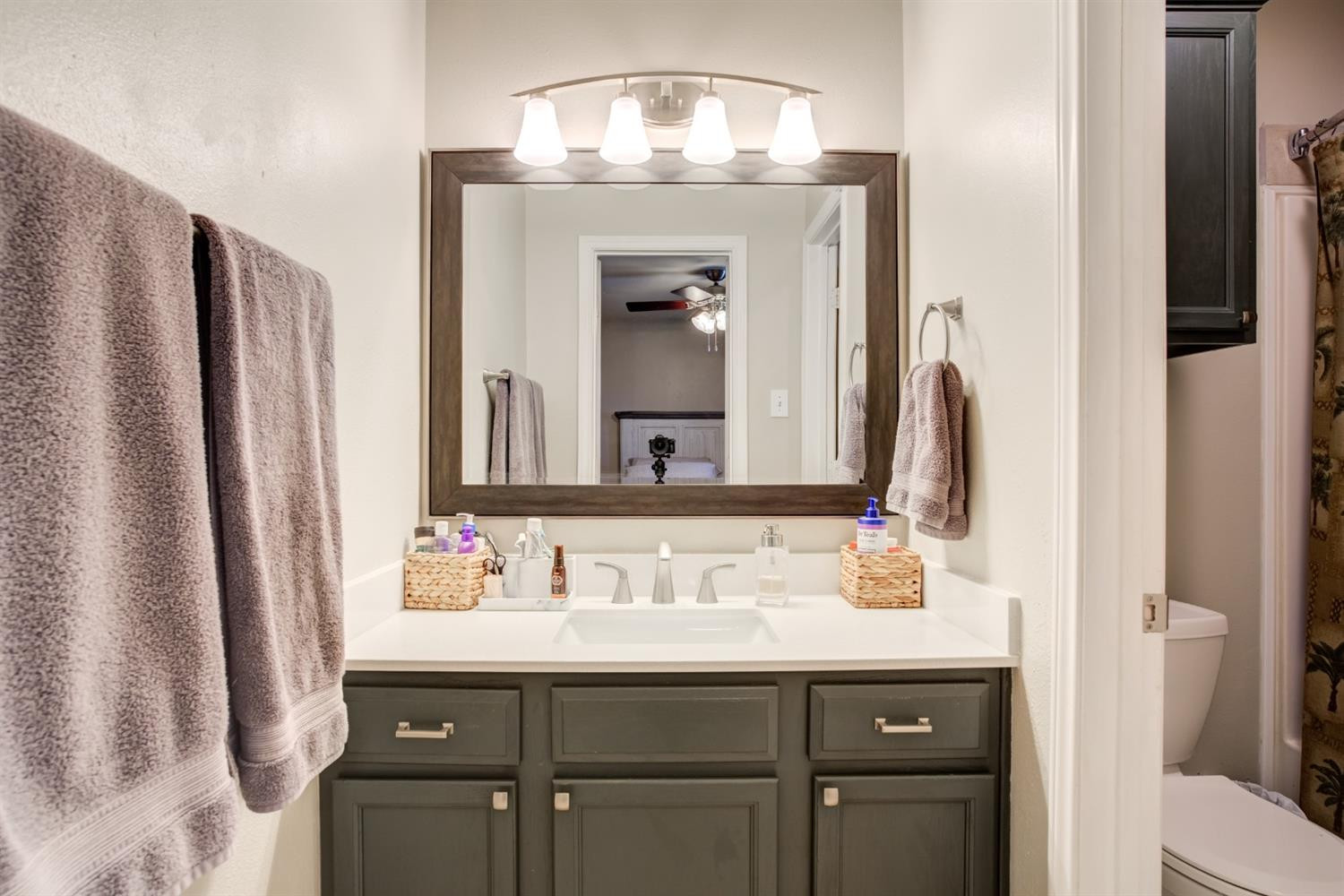 6514 86th Street Lubbock, TX 79424 - Photo 22 of 34 a bathroom with a sink and a mirror