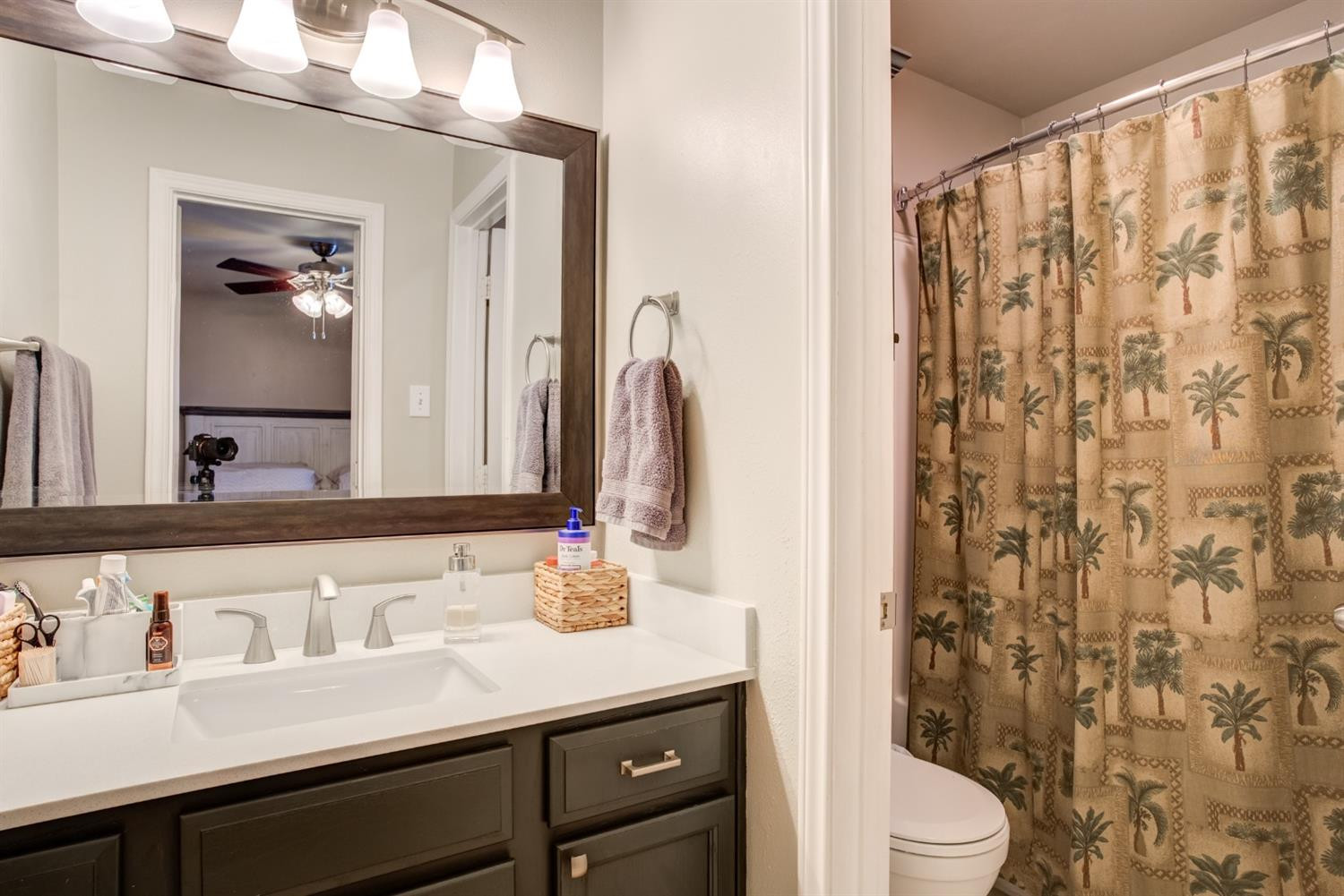 6514 86th Street Lubbock, TX 79424 - Photo 23 of 34 a bathroom with a granite countertop sink a toilet and a mirror