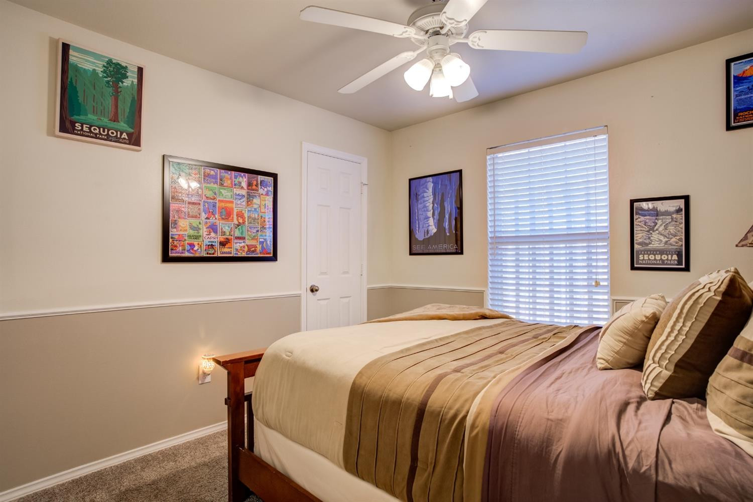 6514 86th Street Lubbock, TX 79424 - Photo 25 of 34 a bedroom with a bed and a chandelier