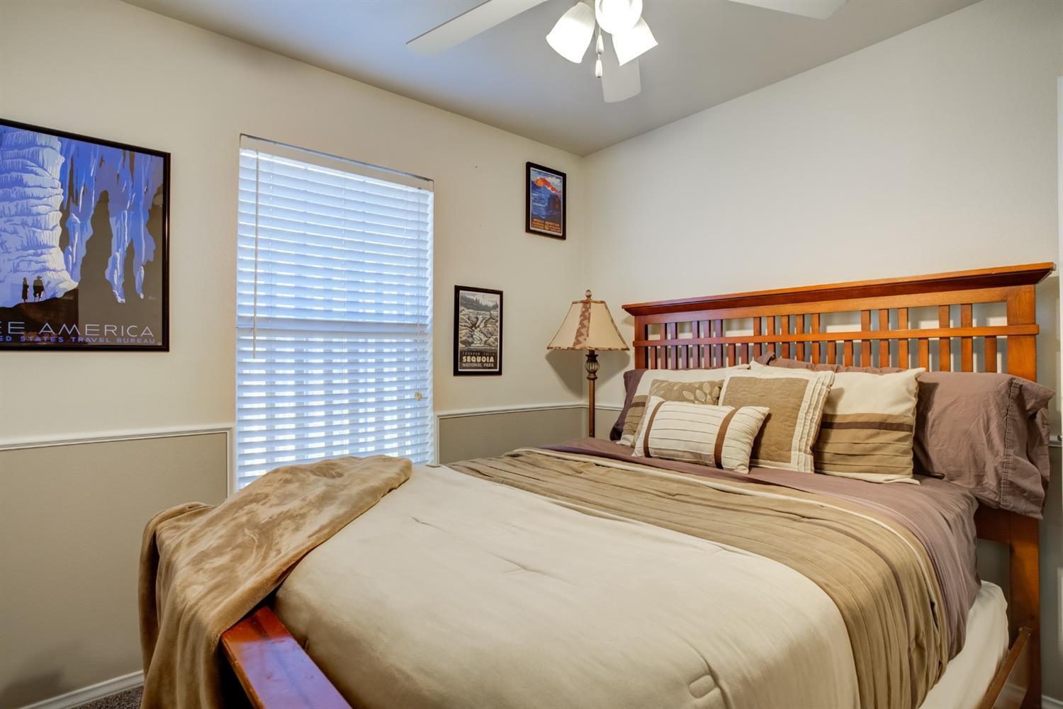 6514 86th Street Lubbock, TX 79424 - Photo 26 of 34 a bedroom with a bed and a chandelier