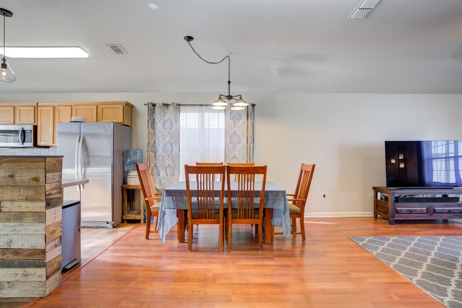 6514 86th Street Lubbock, TX 79424 - Photo 31 of 34 a dining room with furniture floor to ceiling window and potted plants