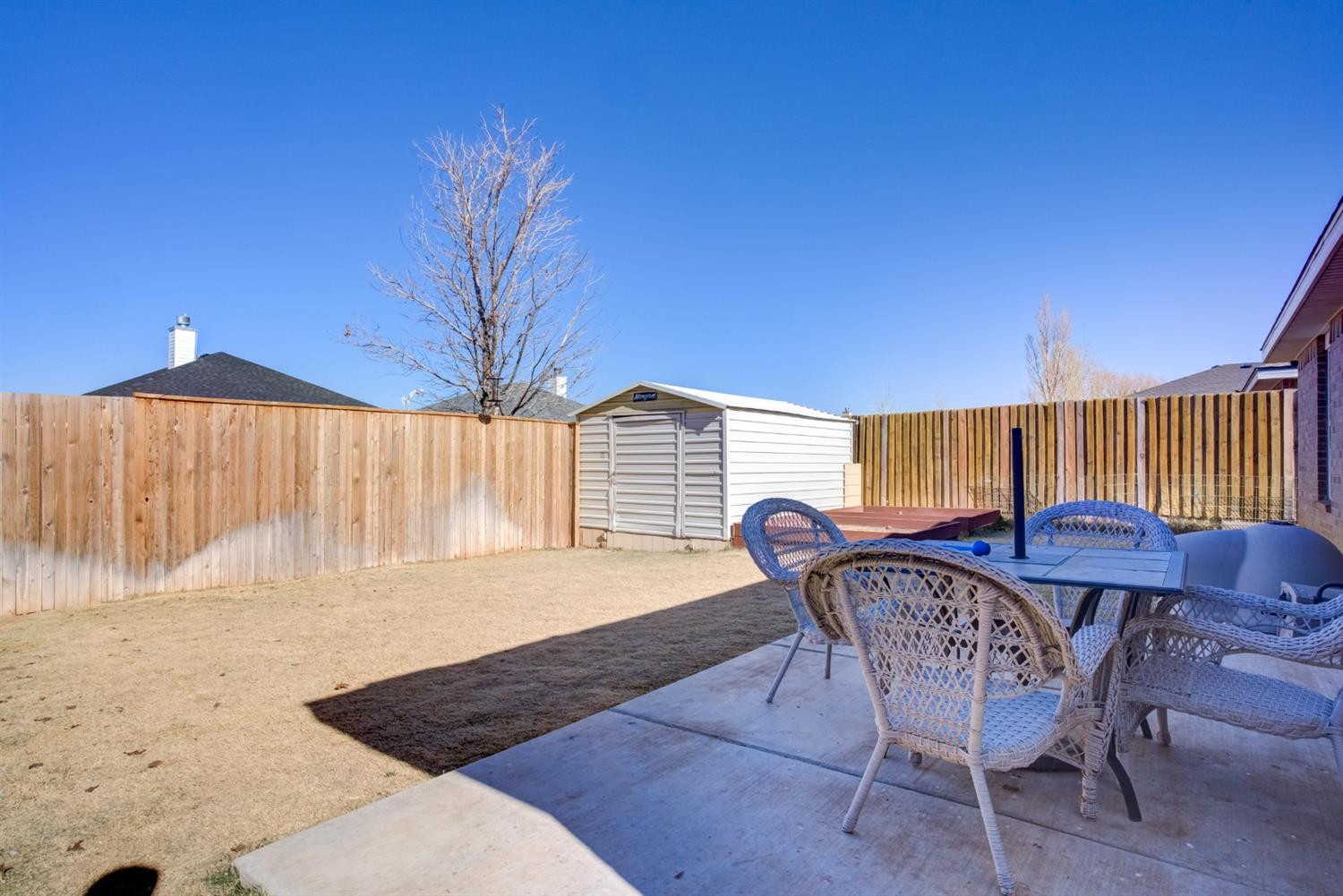 6514 86th Street Lubbock, TX 79424 - Photo 32 of 34 a view of a chairs and table in the patio