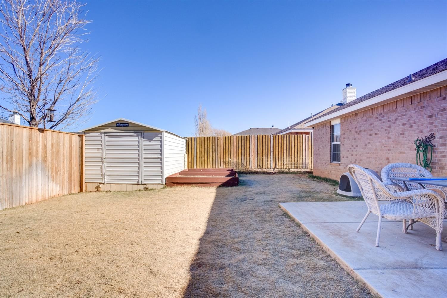 6514 86th Street Lubbock, TX 79424 - Photo 33 of 34 a view of a house with a patio and a yard