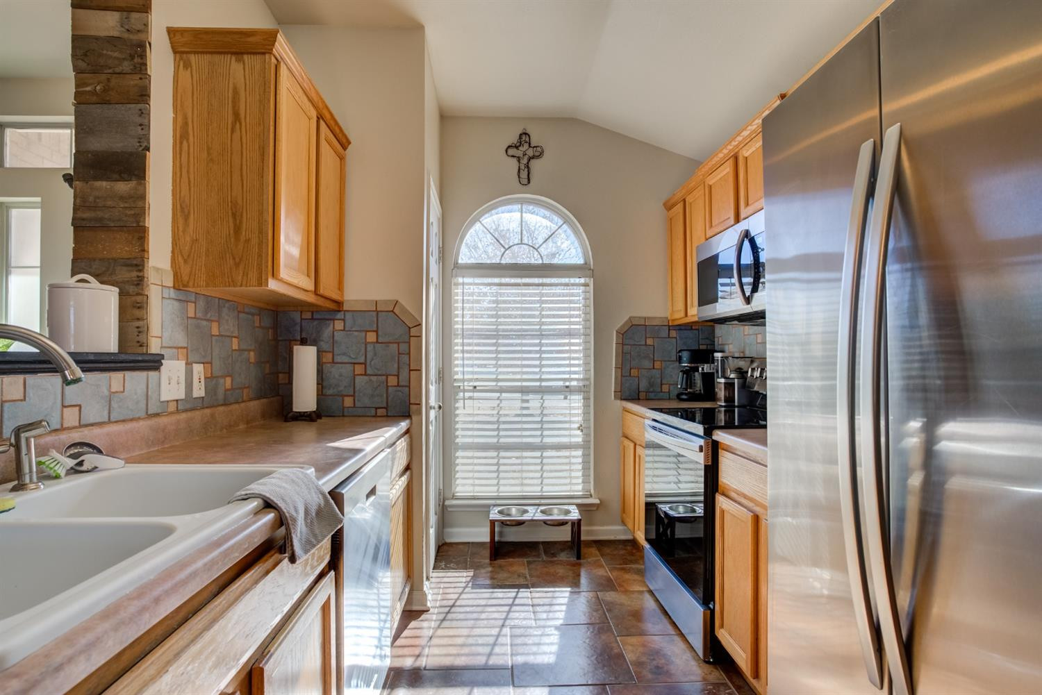 6514 86th Street Lubbock, TX 79424 - Photo 6 of 34 a kitchen with stainless steel appliances a refrigerator sink and stove