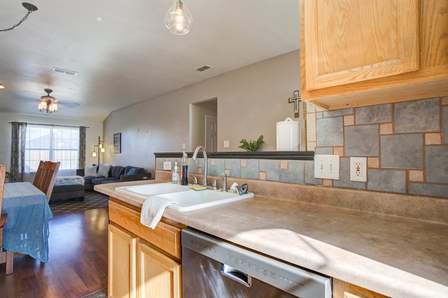 6514 86th Street Lubbock, TX 79424 - Photo 9 of 34 a kitchen with a sink and living room