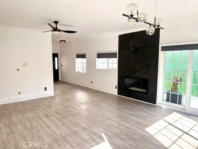 a view of an empty room with a fireplace and a window