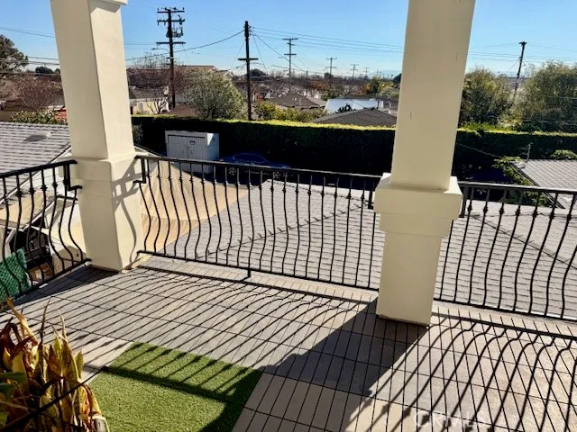 a view of a balcony with wooden floor