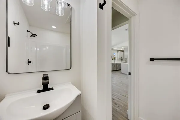 a bathroom with a sink and mirror