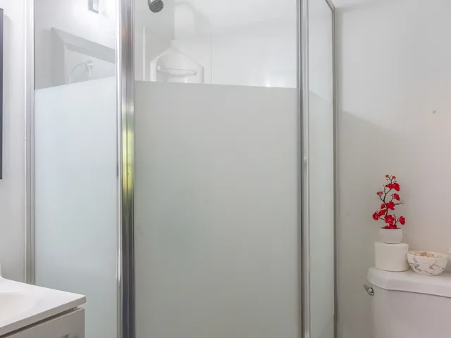 a bathroom with a shower and a sink