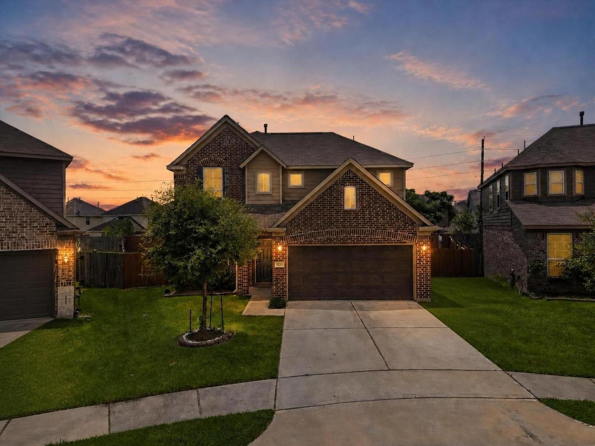 903 Willowick Road Houston, TX 77090 - Photo 1 of 47 The front exterior presents a traditional two-story home with brick accents, a double-wide driveway, and an attached 2-car garage. The evening sky and warm exterior lighting give the home a polished first impression in Eagle Landing.
