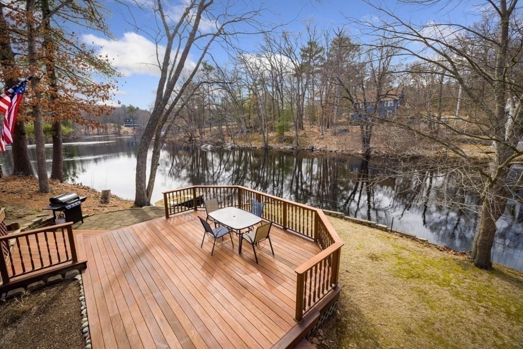 a view of balcony with wooden floor and outdoor seating