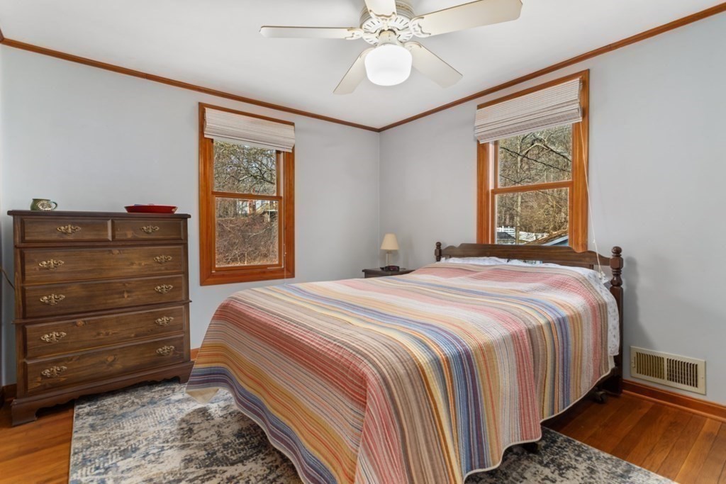 1 Mill Street Middleton, MA 01949 - Photo 25 of 30 a bedroom with a bed and a mirror on the dresser