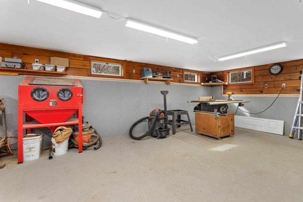 1 Mill Street Middleton, MA 01949 - Photo 28 of 30 a storage room with lots of clutter and bicycles