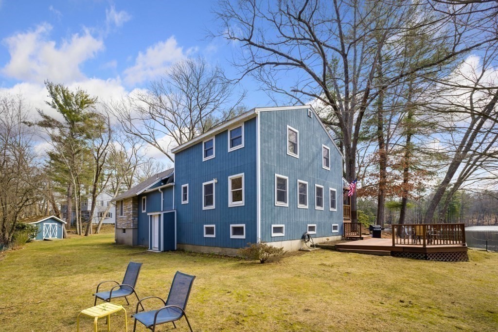 1 Mill Street Middleton, MA 01949 - Photo 3 of 30 a view of a building with a swimming pool and trees in the background