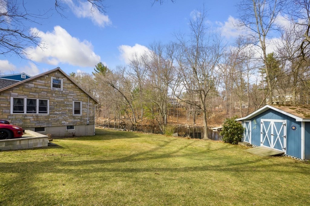 1 Mill Street Middleton, MA 01949 - Photo 9 of 30 a front view of house with yard and trees in the background