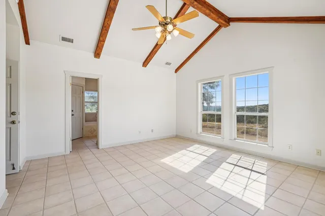 a bedroom with a bed and glass window
