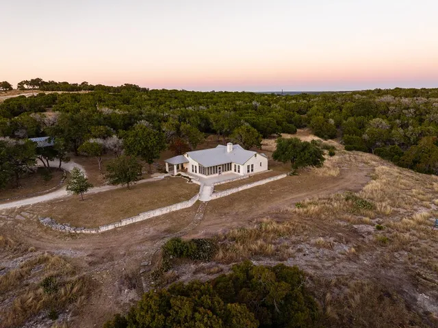 a view of a city with lush green forest