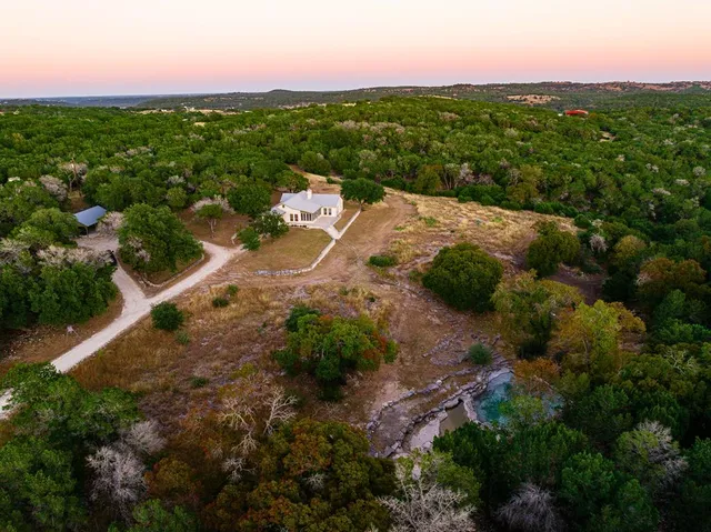 a view of a backyard of a house with a yard