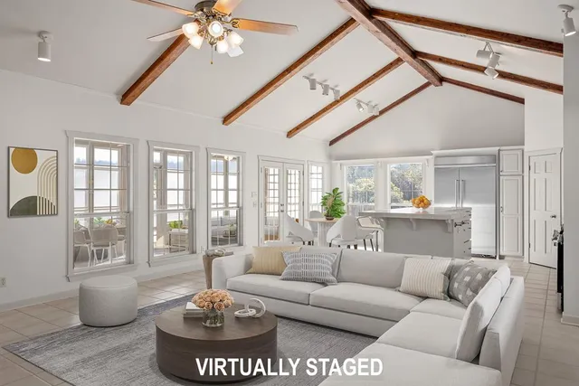 a view of an empty room with a fireplace and windows