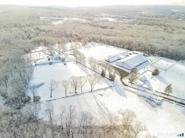 a view of a house with a yard covered in snow