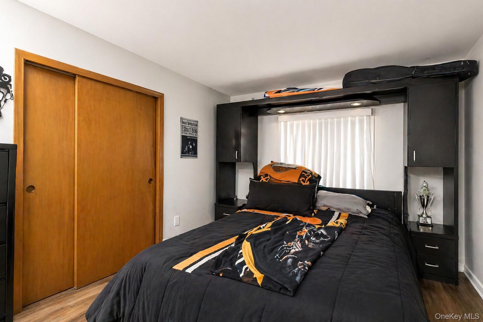 11 Seaford Road Mastic Beach, NY 11951 - Photo 12 of 19 a bed sitting in a bedroom next to a window