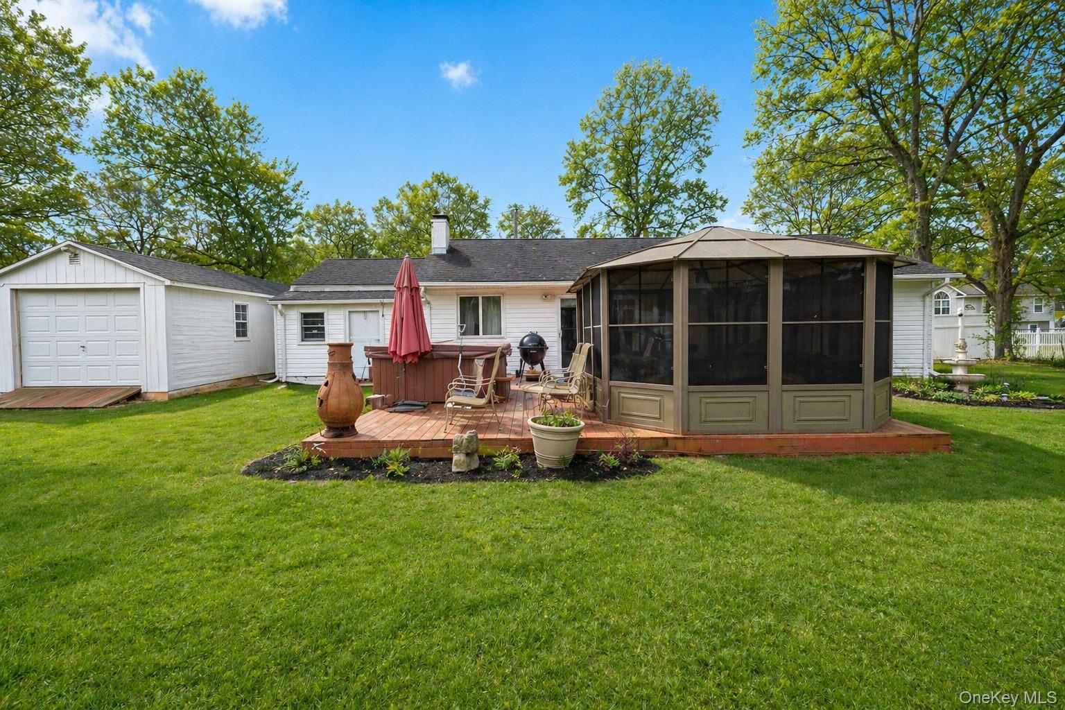 11 Seaford Road Mastic Beach, NY 11951 - Photo 15 of 19 a view of a house with a yard and sitting area