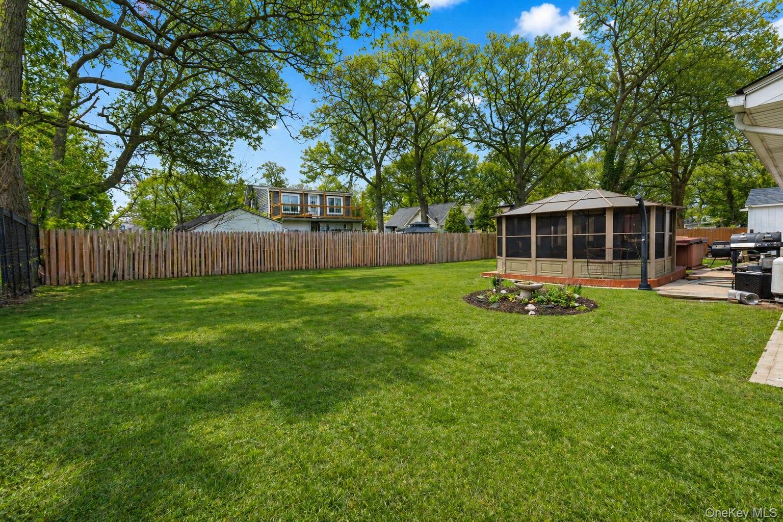 11 Seaford Road Mastic Beach, NY 11951 - Photo 16 of 19 a view of a house with backyard and sitting area