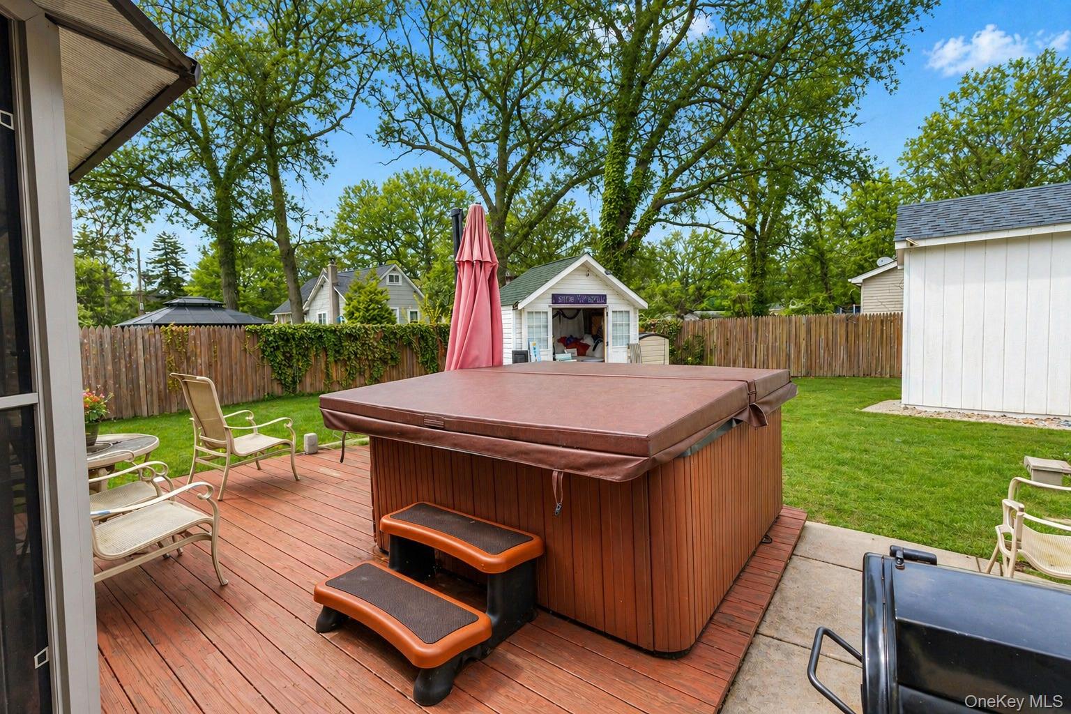 11 Seaford Road Mastic Beach, NY 11951 - Photo 17 of 19 a view of a deck with a table chairs and a backyard