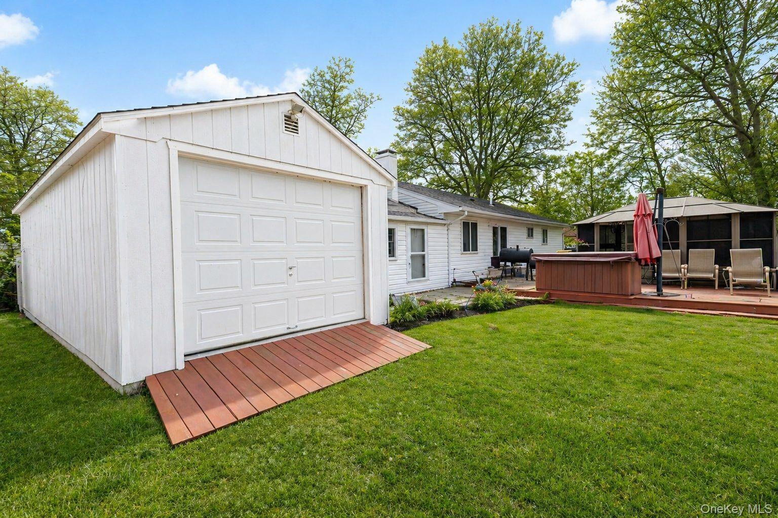 11 Seaford Road Mastic Beach, NY 11951 - Photo 19 of 19 a front view of house with yard and outdoor seating