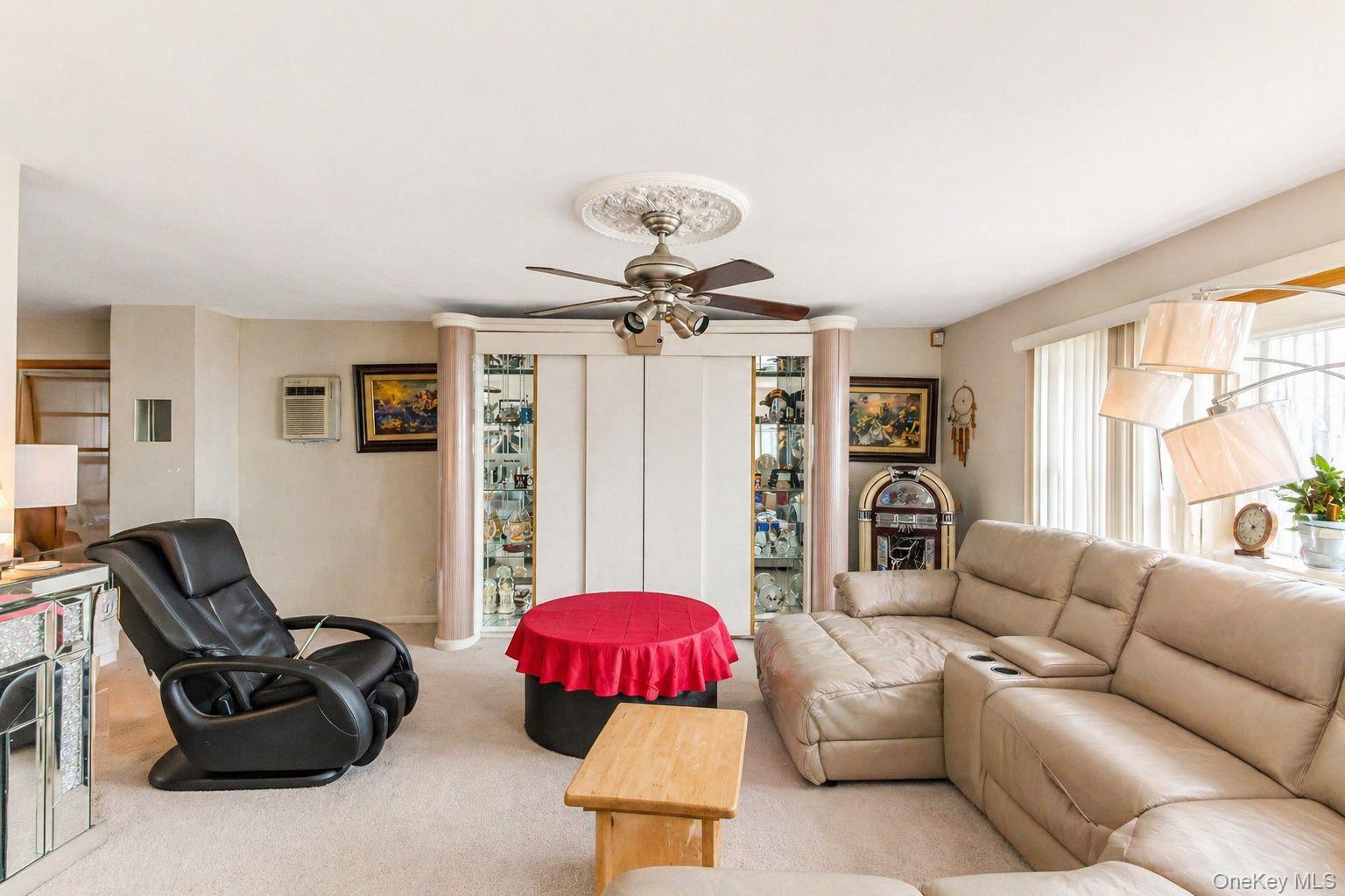 11 Seaford Road Mastic Beach, NY 11951 - Photo 6 of 19 a living room with furniture and a chandelier