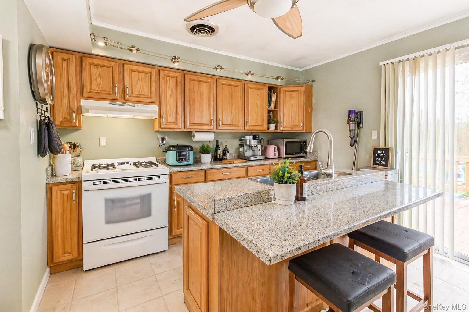 11 Seaford Road Mastic Beach, NY 11951 - Photo 7 of 19 a kitchen with stainless steel appliances granite countertop a sink stove and refrigerator