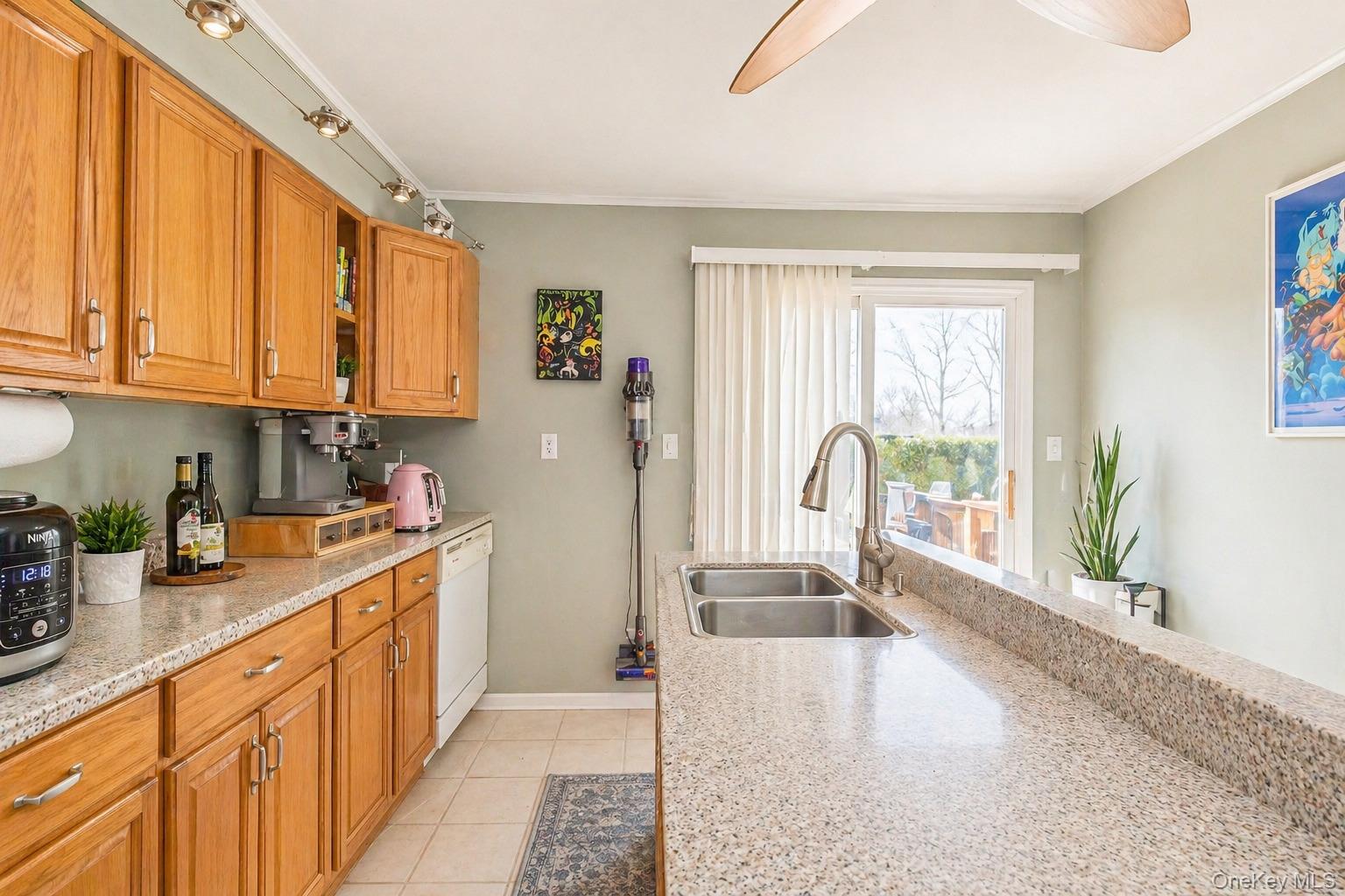 11 Seaford Road Mastic Beach, NY 11951 - Photo 8 of 19 a large kitchen with stainless steel appliances granite countertop a large window a sink and white cabinets
