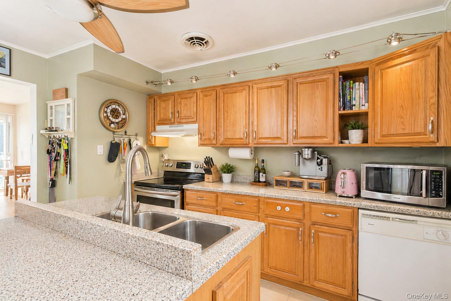 11 Seaford Road Mastic Beach, NY 11951 - Photo 9 of 19 a kitchen with granite countertop a sink cabinets stainless steel appliances and a window