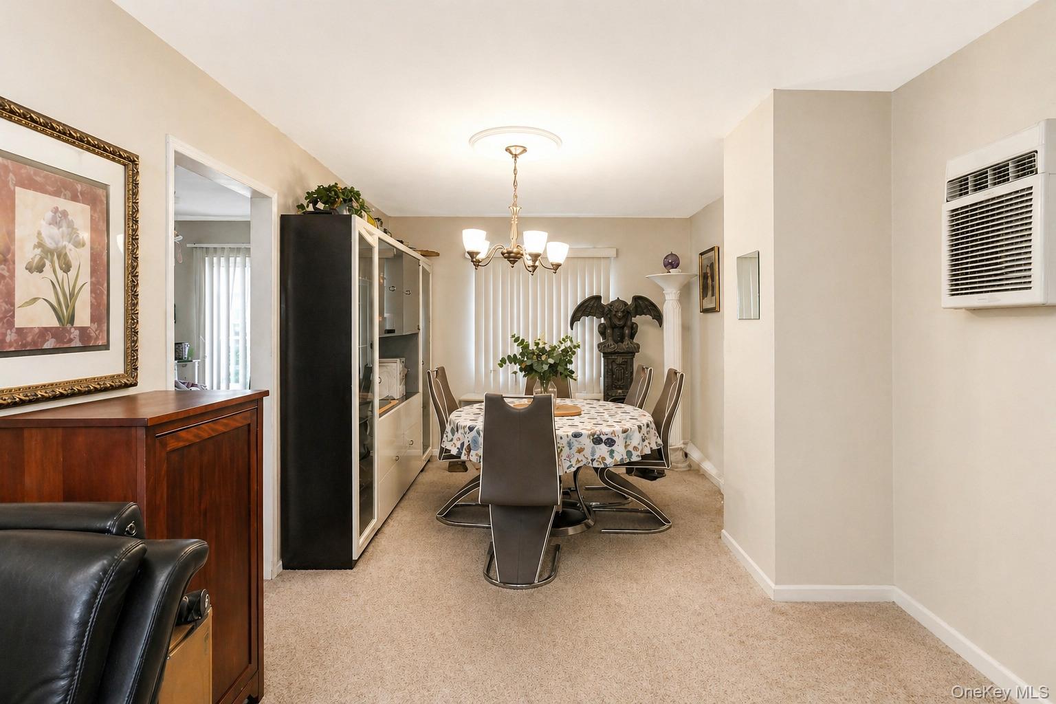 11 Seaford Road Mastic Beach, NY 11951 - Photo 10 of 19 a dining room with furniture and chandelier