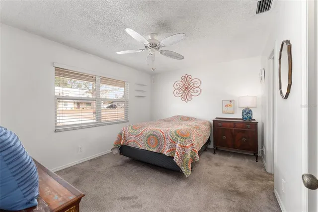 a spacious bedroom with a bed and a window